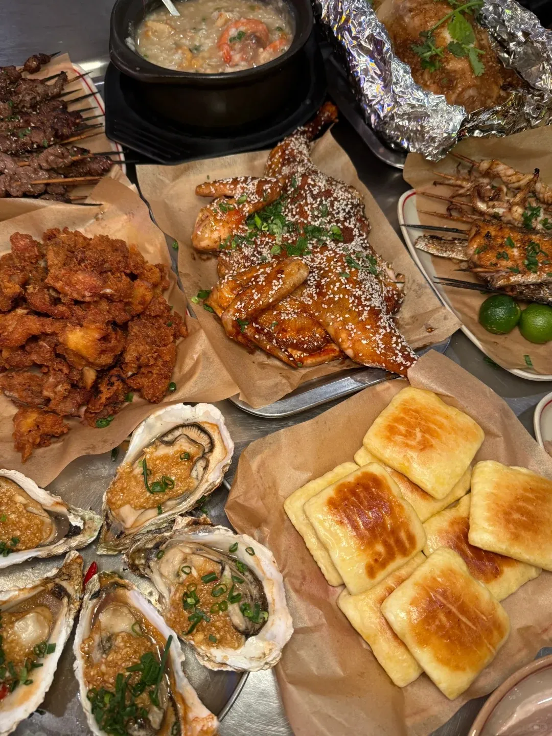 Garlic-grilled oysters and skewers at a Sanya BBQ stall