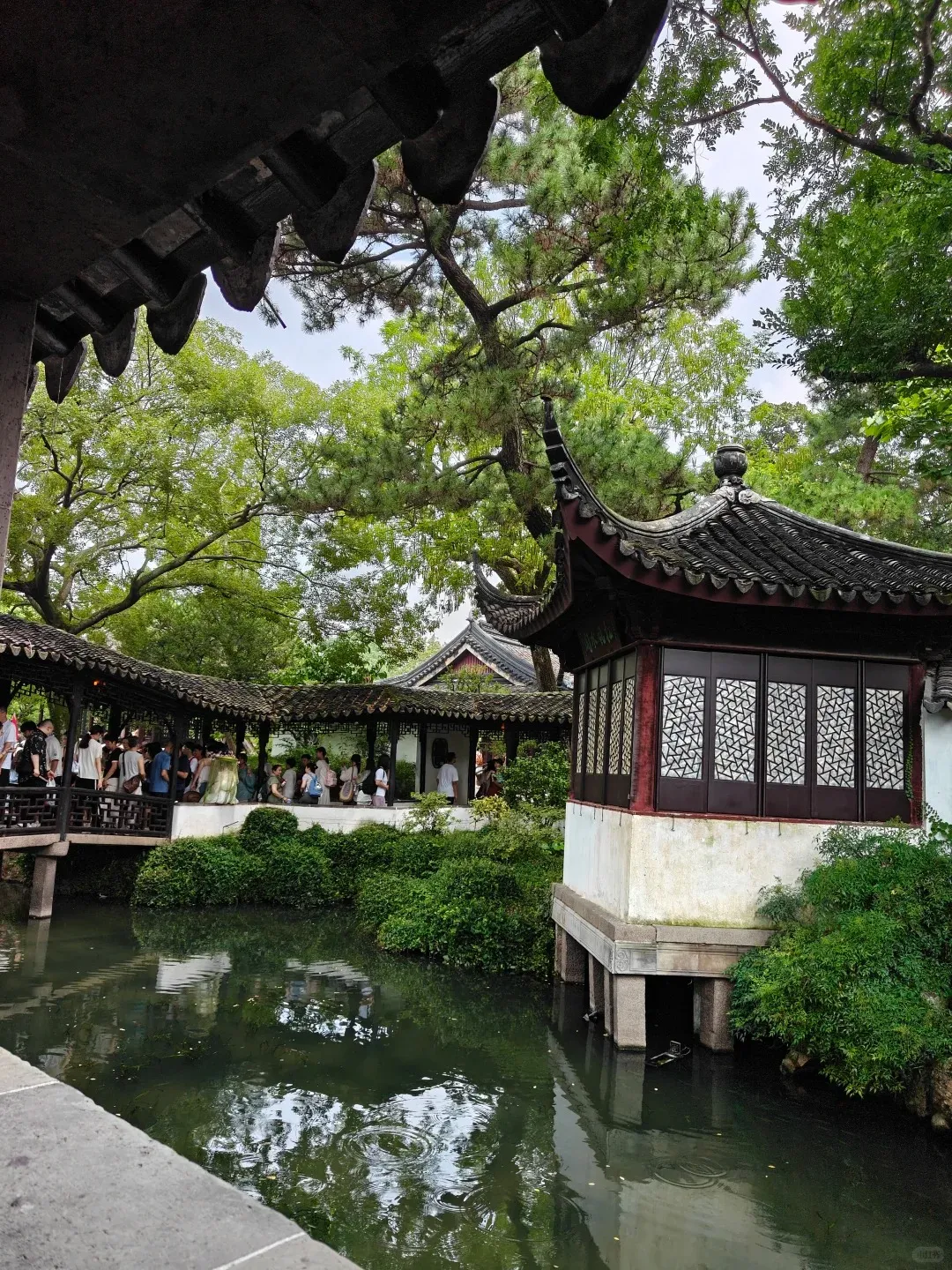 A covered bridge and pavilion inside the Humble Administrator's Garden