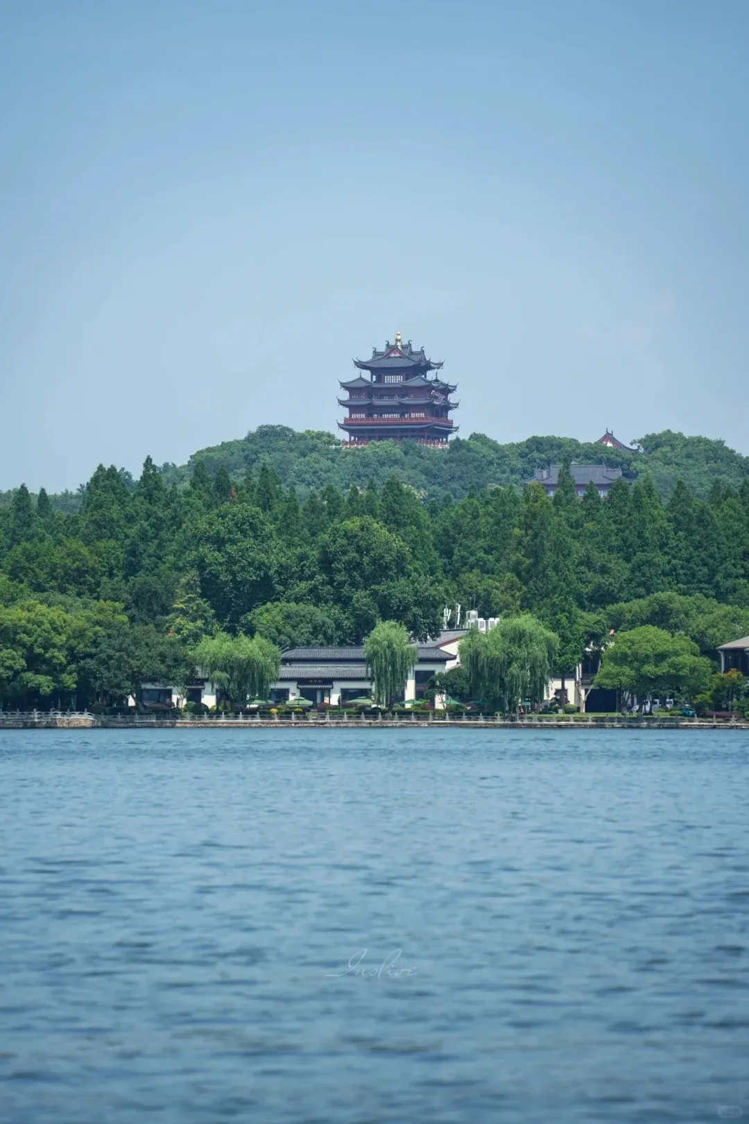 West Lake shoreline with willows and calm water in Hangzhou