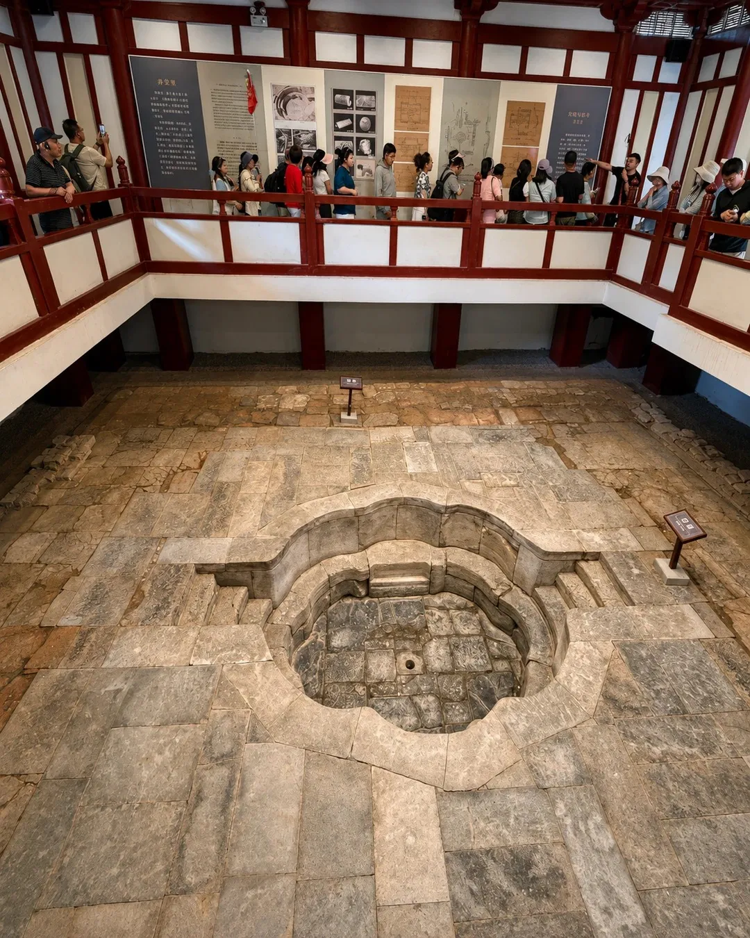 The restored lotus-shaped royal hot spring pool with mist and floating lotus flowers