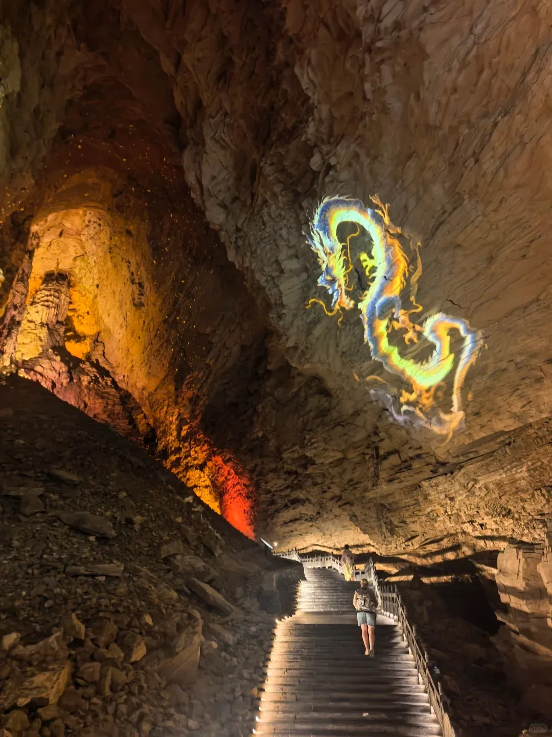 Illuminated karst formations inside Yellow Dragon Cave